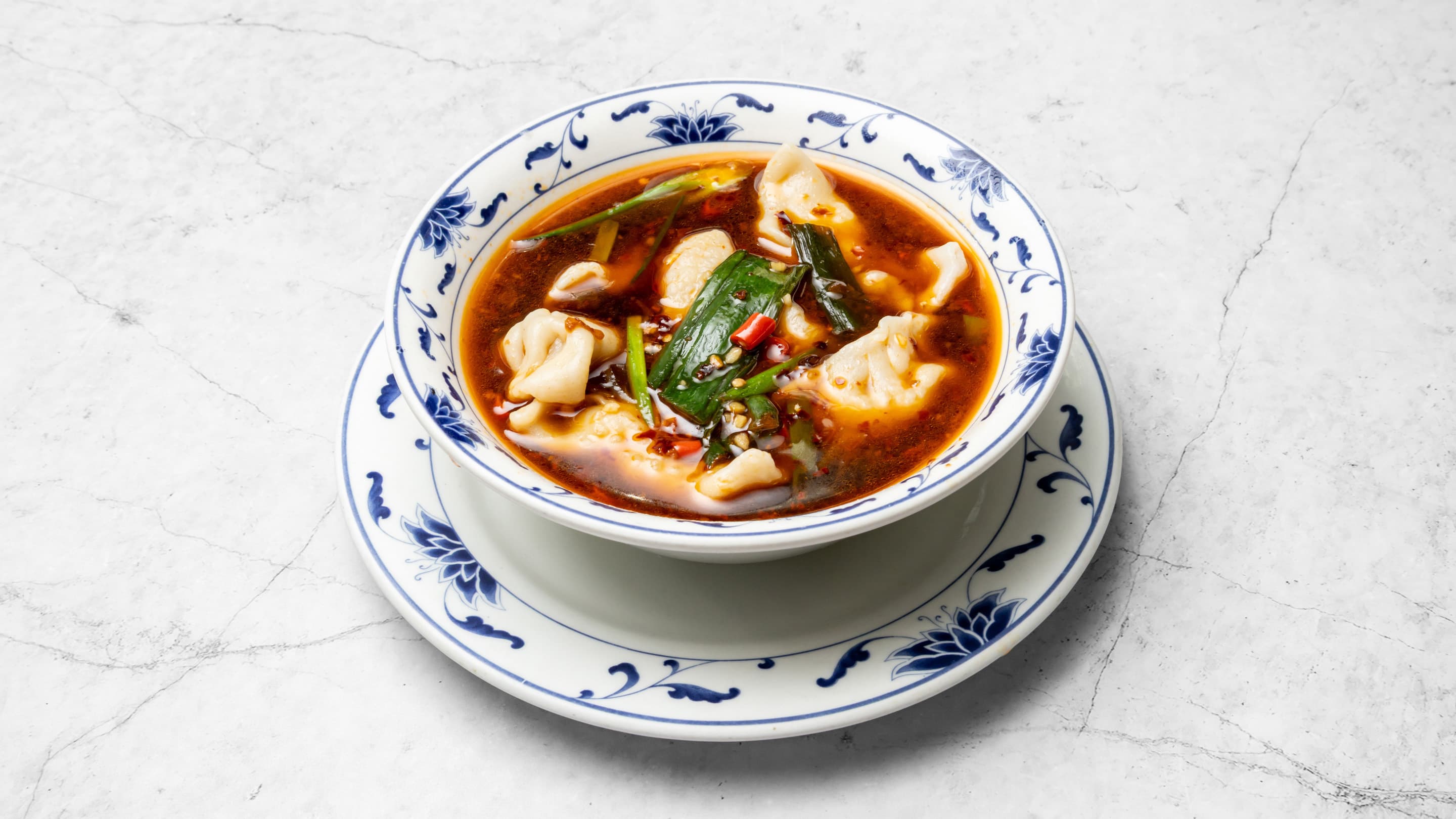 Steamed vegetarian dumplings in dumpling sauce from New Wok's Cooking