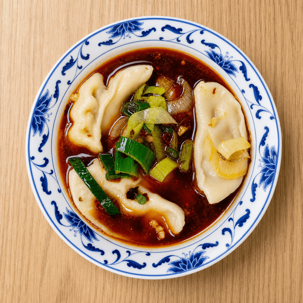 Steamed chicken dumpling in dumpling sauce at New Wok’s Cooking